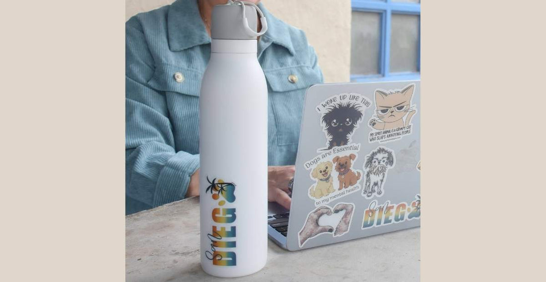 Laptop and water bottle decorated with JC Pet Designs pet stickers showing creative sticker uses