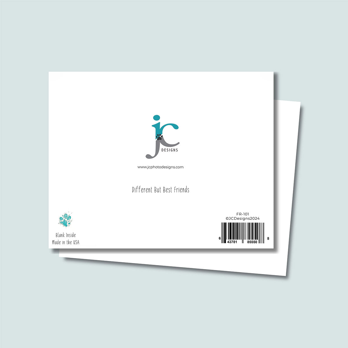 back of Different But Best Friends greeting card showing JC Pet Designs logo and unique tagline message that says "Different But Best Friends", in bottom left corner is Oz's paw print in teal color and text below paw print says "blank inside, made in the USA", and in the bottom right corner is the sku and barcode