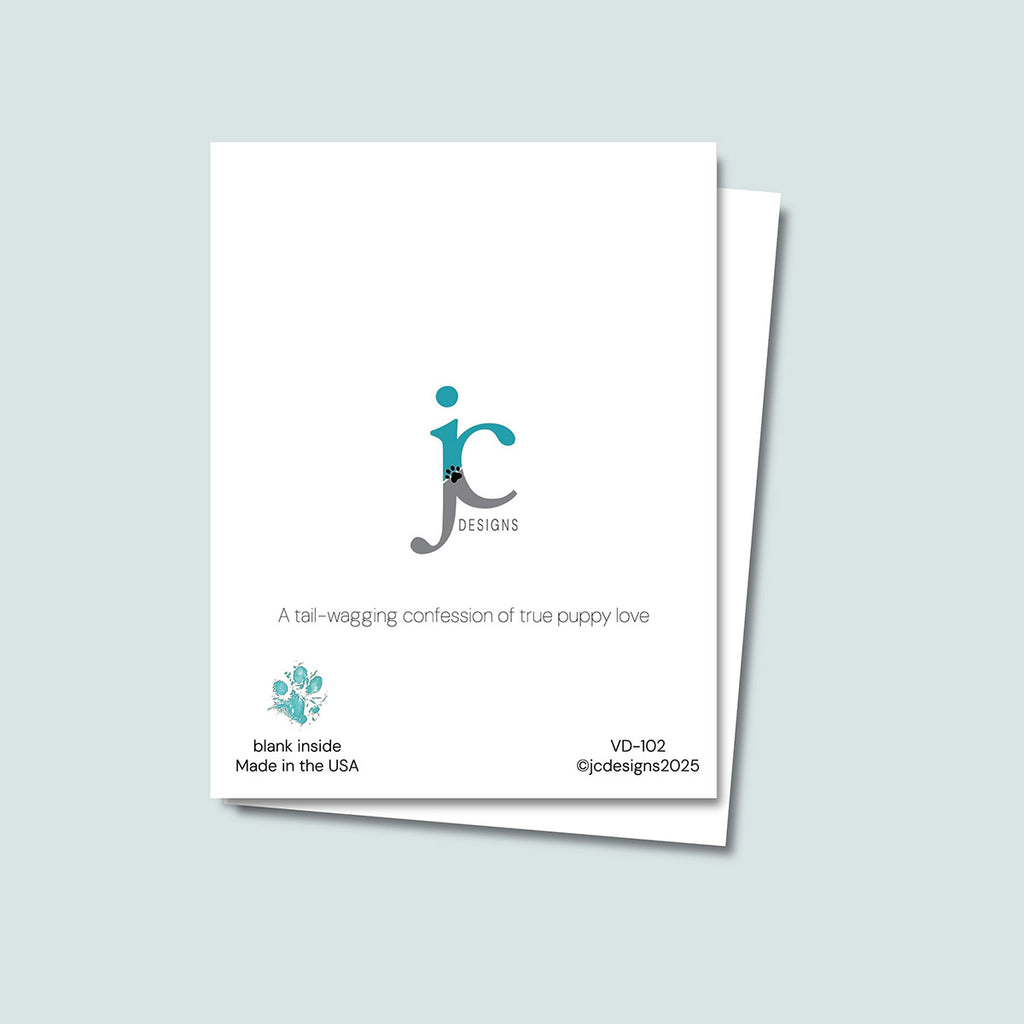 back of Mutts About You Valentine's Day card showing JC Pet Designs logo and unique tagline that reads "A tail-wagging confession of true puppy love", in bottom left corner of the white card is Oz's paw print in teal and text that reads "blank inside, made in the USA", in the bottom right corner of the white card is the sku and copyright @jcpetdesigns2025