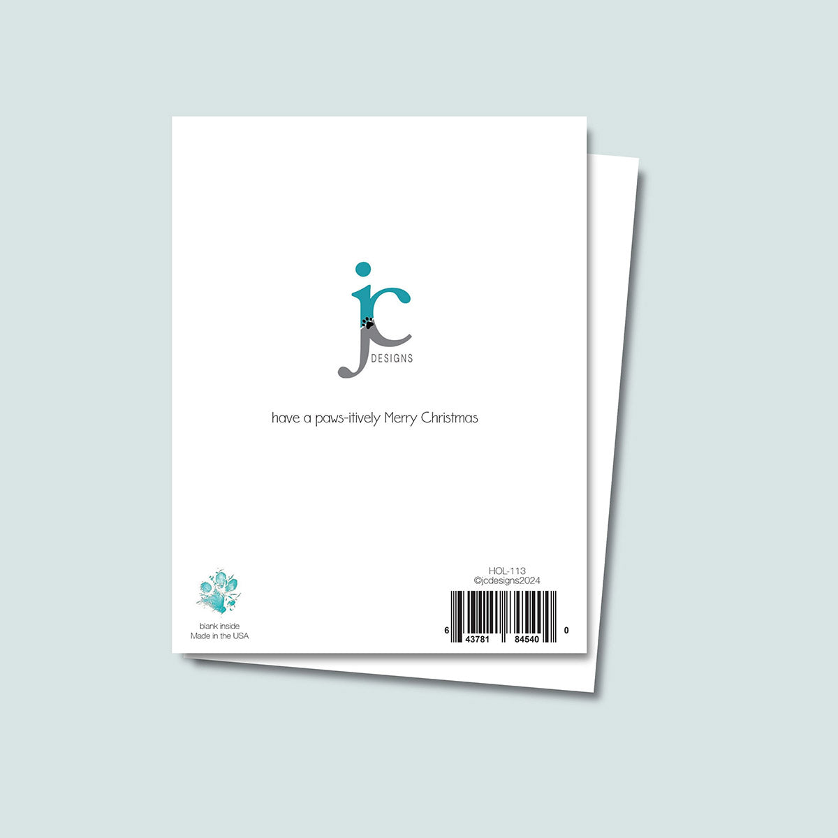 back of Paw Print Christmas Tree card showing JC Pet Designs logo and unique message tagline "Have a Paws-itively Merry Christmas", Oz's paw print in teal in lower left corner above words blank inside and made in USA, sku and barcode on right bottom corner of card