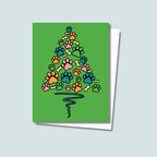 Paw Print Christmas Tree card featuring blue orange pink green paws and yellow bones shaped like a Christmas Tree with a blue wavy line as the tree trunk on a green background
