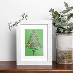 framed Paw Print Christmas Tree card featuring blue orange pink green paws and yellow bones shaped like a Christmas Tree with a blue wavy line as the tree trunk on a green background, frame is not included with purchase