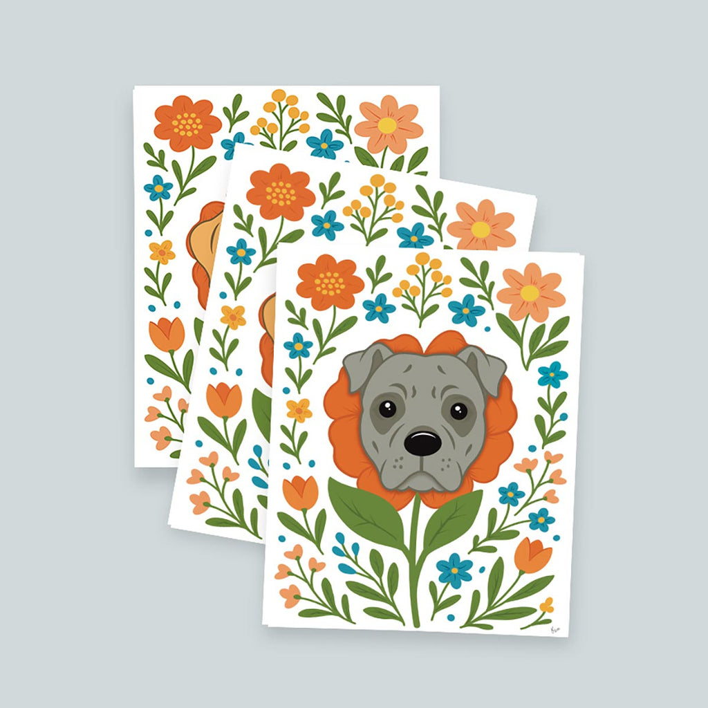 stack of 3 Pit Bull Flower art prints featuring a gray Pit Bull's face framed by an orange flower surrounded by orange and teal flowers and green stems leaves on a white background