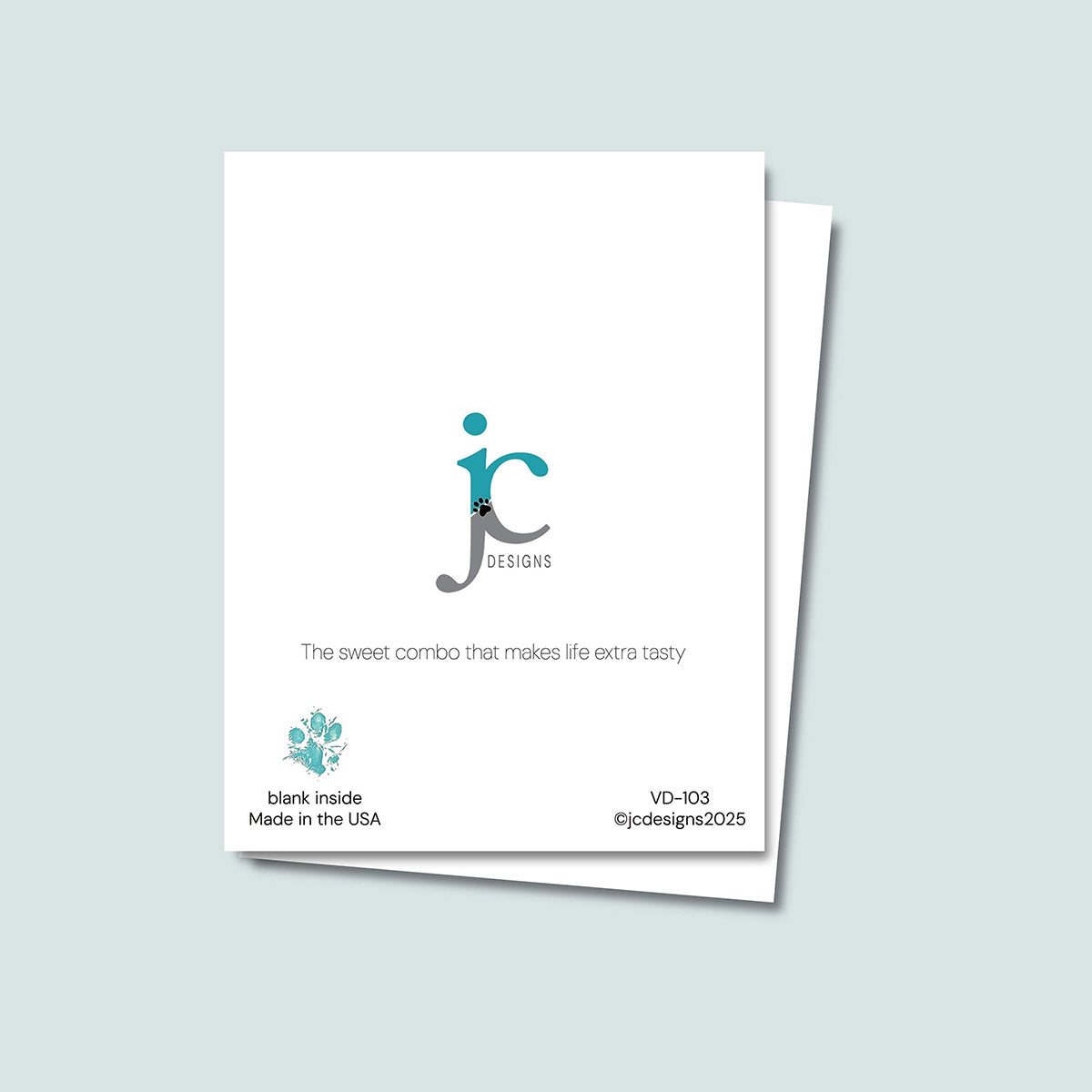 back of Pup Cup card showing JC Pet Designs logo and unique tagline that reads  "The sweet combo that makes life extra tasty", in the bottom left corner of the white card is Oz's paw print in teal and text that reads "blank inside, made in the USA", the bottom right corner of the white card is the sku and copyright @jcpetdesigns2025