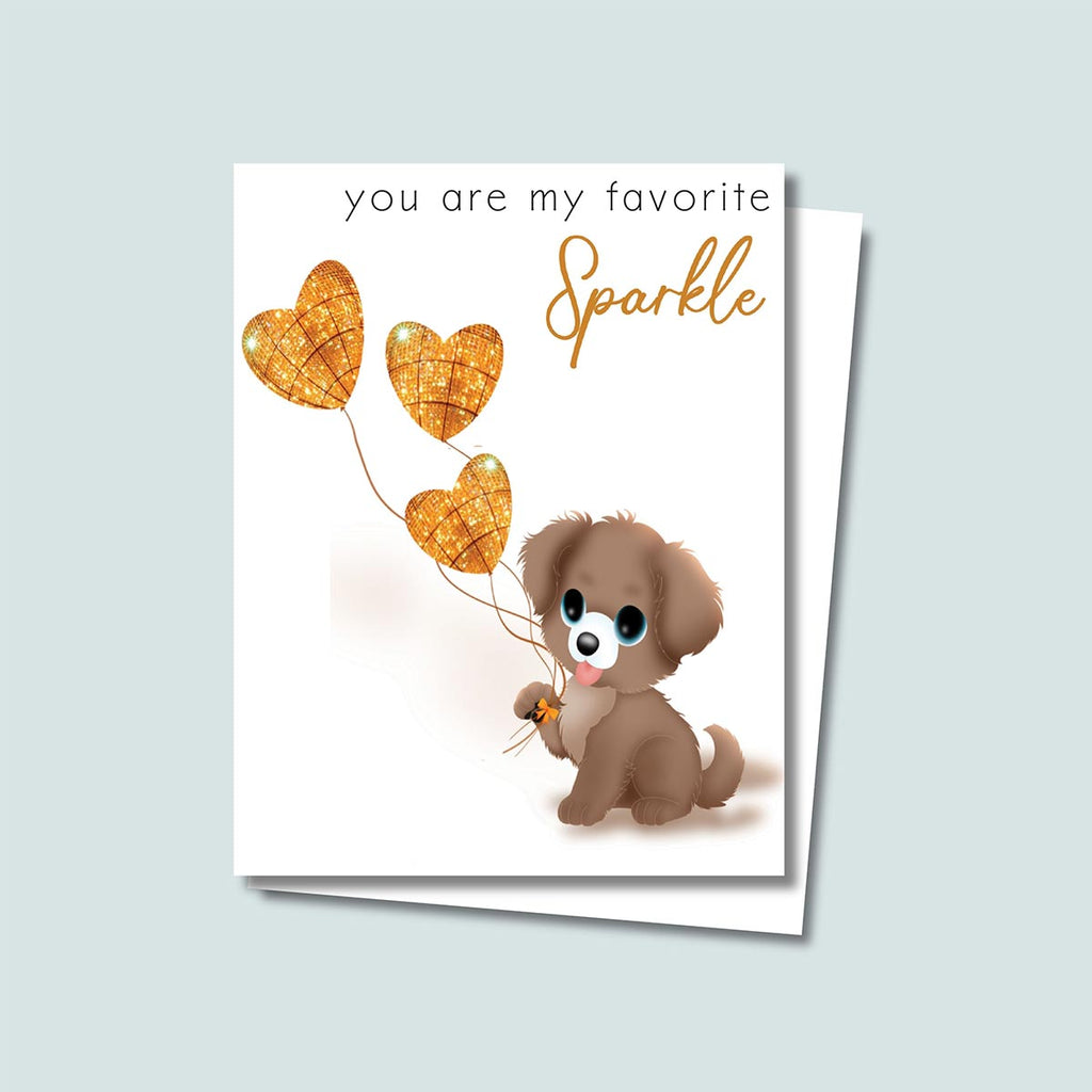 "You Are My Favorite Sparkle" greeting card featuring a cute brown puppy holding 3 glittery gold heart-shaped  balloons, black text in simple font at top of card says "you are my favorite" then right below this text still at top of card is gold text in cursive says "Sparkle", the card has a white background