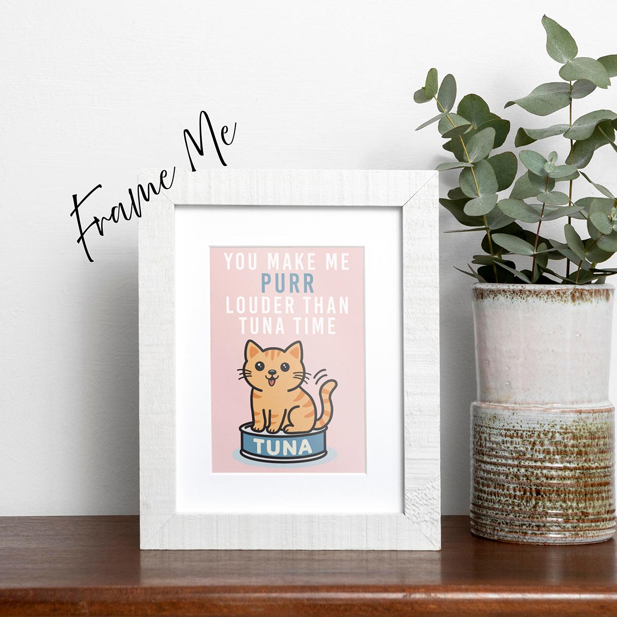 framed Tuna Time card featuring a cute orange cat sitting on a can of tuna, text on top of card reads "You Make Me Purr Louder than Tuna Time", the card has a muted pink background