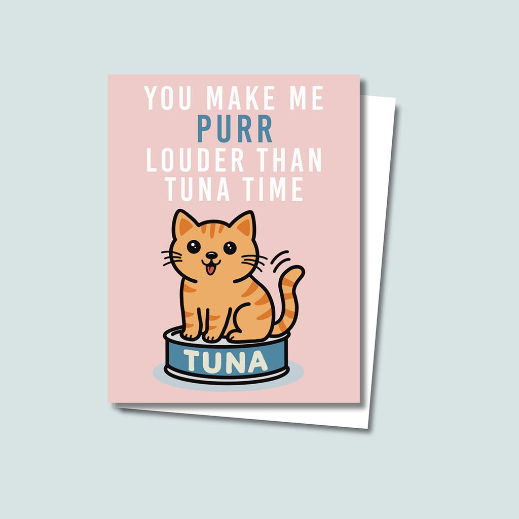 Tuna Time card featuring a cute orange cat sitting on a can of tuna, text on top of card reads "You Make Me Purr Louder than Tuna Time", the card has a muted pink background
