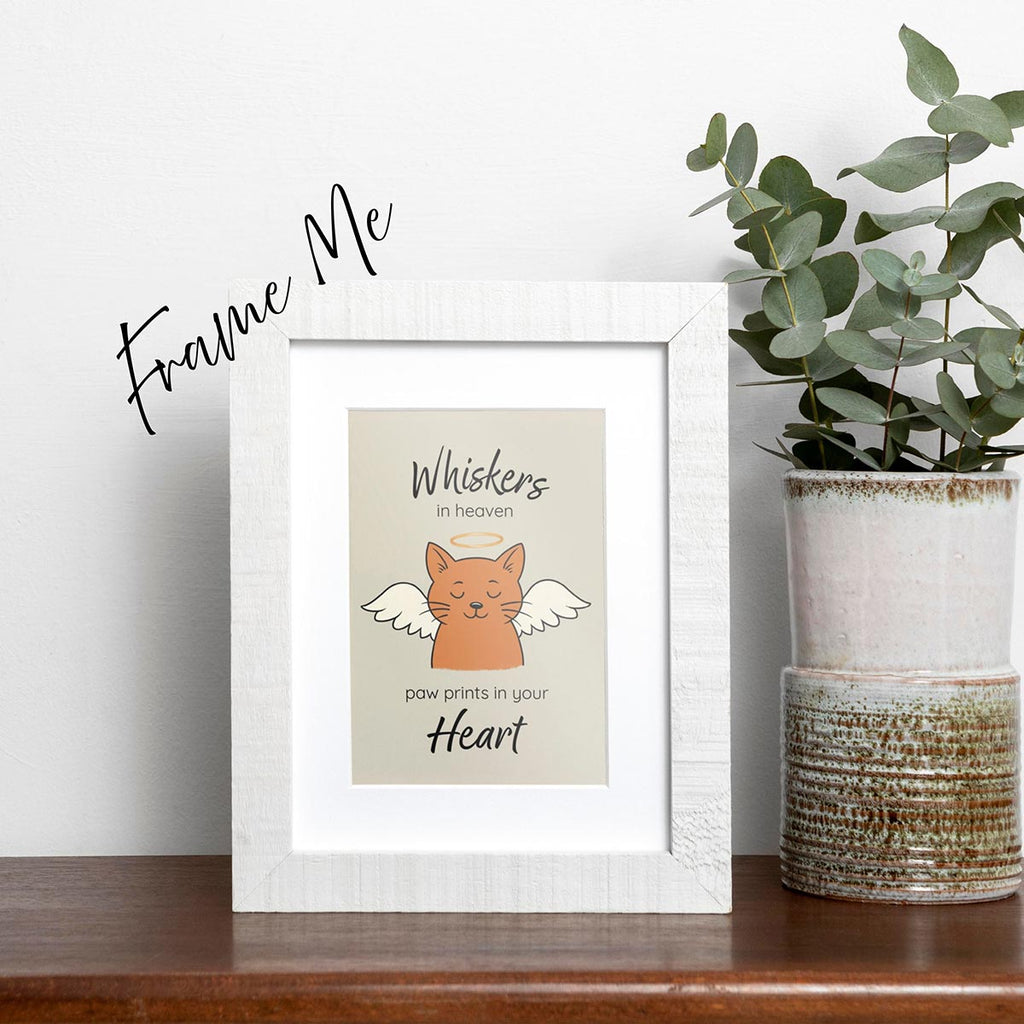 framed Whiskers in Heaven pet loss sympathy card featuring an orange cat with angel wings and gold halo, text reads Whiskers in heaven at top of card and paw prints in your heart at bottom of card, card has a muted light brown background, frame not included in purchase
