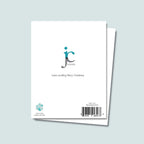 back of We Woof You a Merry Christmas card showing JC Pet Designs logo and a unique tagline message "have a woofing Merry Christmas", Oz's paw print in teal is in bottom left corner right above words "blank inside, made in the USA" and sku and barcode on bottom right corner