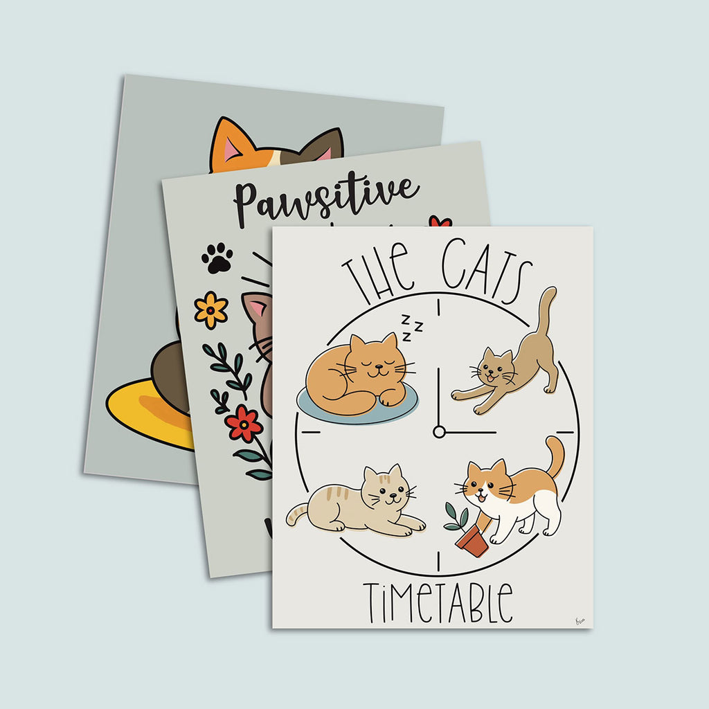 set of three cat=themed art prints stacked, featuring on top The Cats' Timetable art print featuring four illustrated cats lounging, stretching, napping, and playing around a clock design, text The Cat's is arched over the top and text Timeable arched under the bottom, the image is on a light tan background