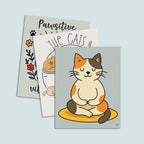 set of three cat-themed art prints displays together featuring on top a minimalist cat yoga art print featuring brown tan and orange calico cat sitting cross-legged in a meditative post on a yellow mat with muted blue green background