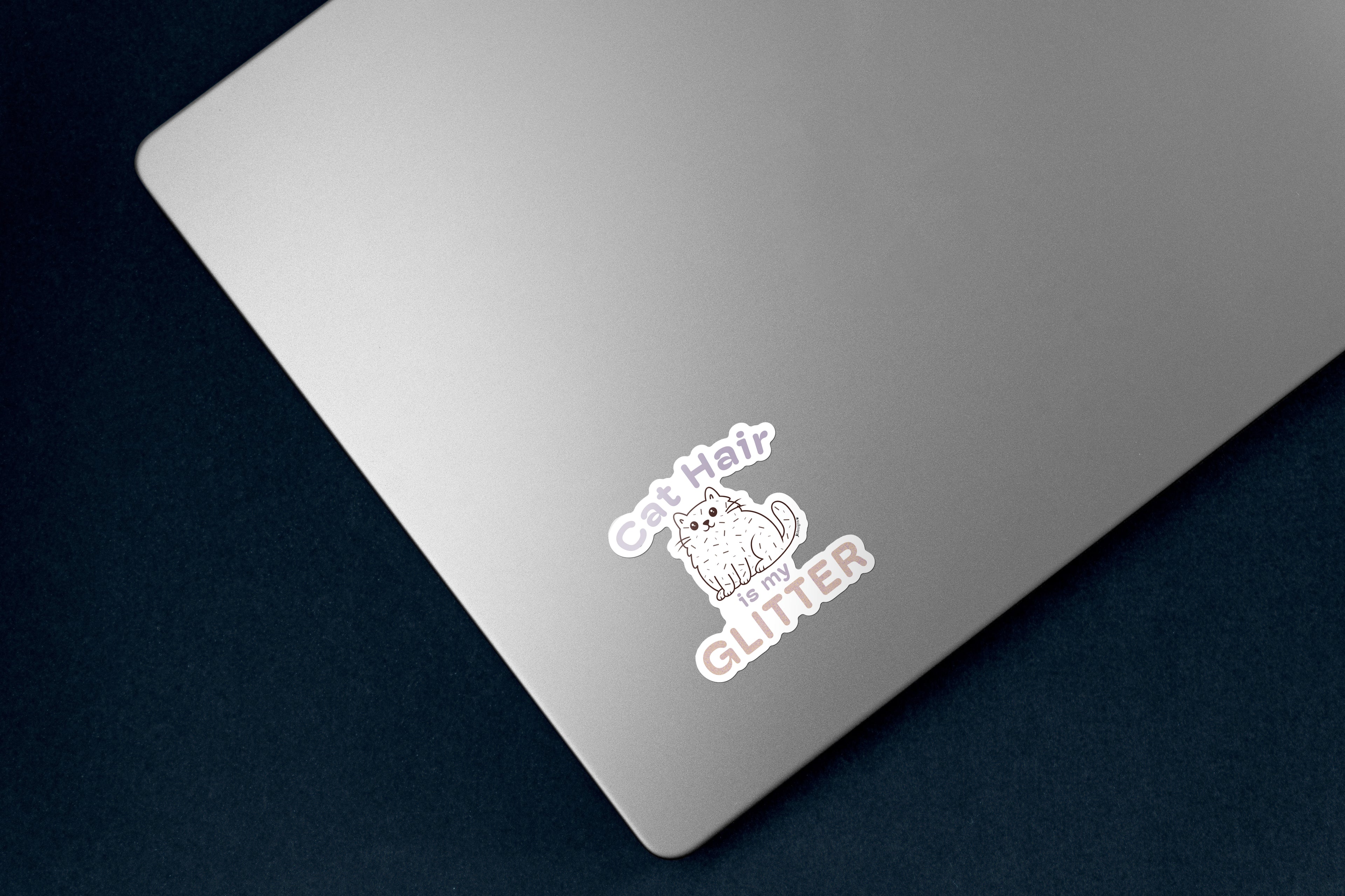 Sticker of a fluffy white cartoon cat covered in scattered strands of cat hair. Above the cat, the phrase 'Cat Hair' is written in soft purple text, with 'is my' is smaller matching text below the cat. The word 'GLITTER' is prominently displayed at the bottom in large, sparkling textured letters. The design is outlined in white. the 3 inch sticker is on a silver laptop. 