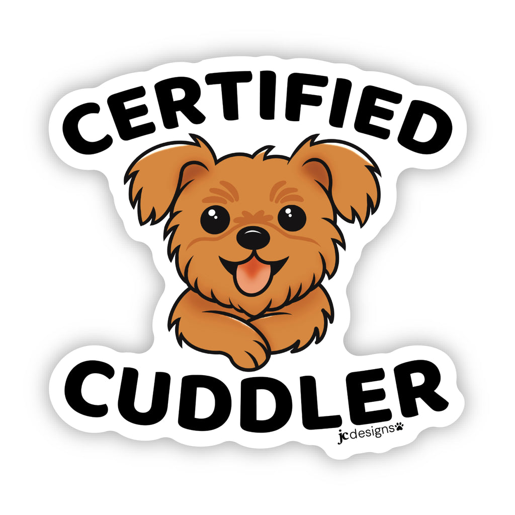 Sticker design featuring a cute, fluffy brown dog with a happy expression, tongue out, and front paws crossed. The text 'Certified' arched above the dog in bold black letters, and 'Cuddler' is written below in matching font. The design is outlined in white.