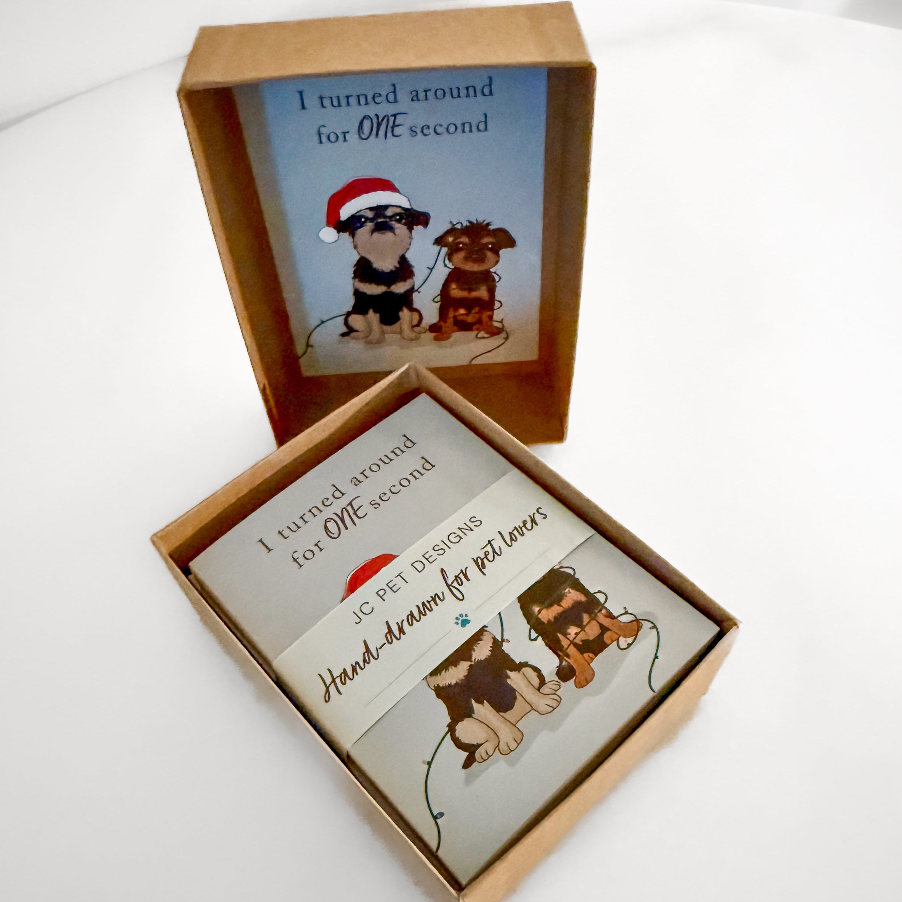 Box of hand-drawn custom greeting cards with illustrations of dogs and text on a white background