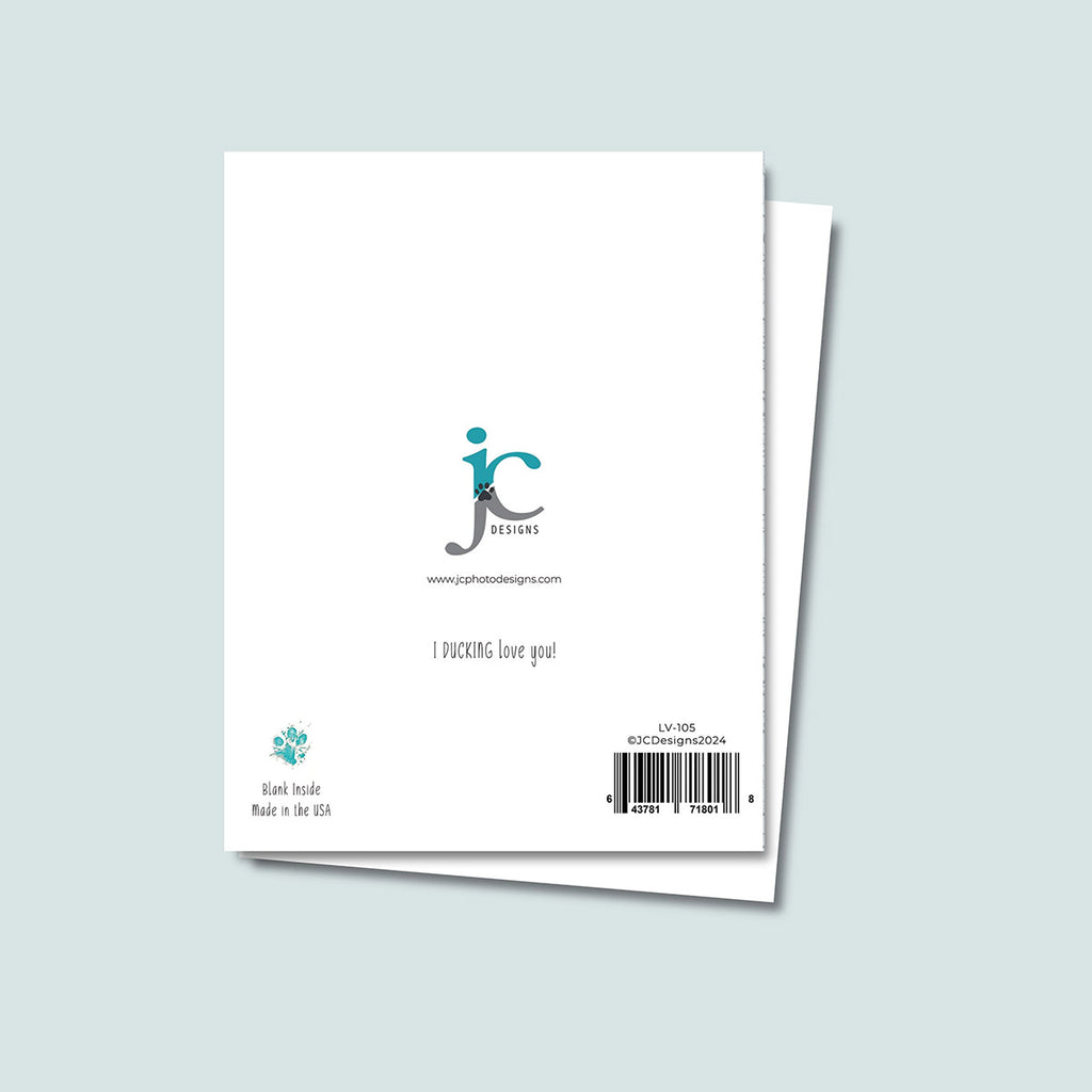 back of I Ducking Love You greeting card showing JC Pet Designs logo and a message text that says "I Ducking Love You", in bottom left corner is Oz's paw print in teal color and text reading "blank inside, made in the USA", sku and barcode are on the bottom right corner of card
