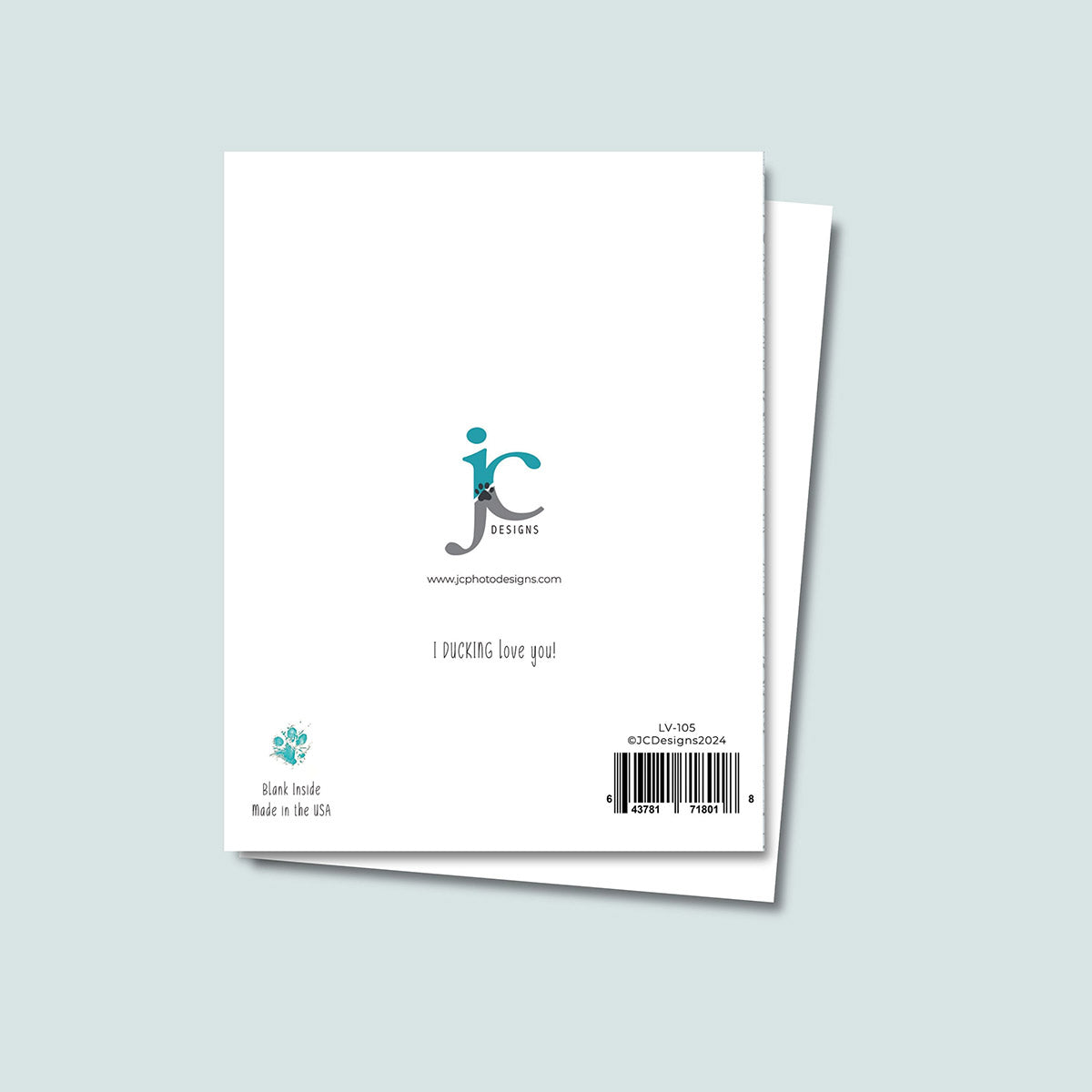 back of I Ducking Love You greeting card showing JC Pet Designs logo and a message text that says "I Ducking Love You", in bottom left corner is Oz's paw print in teal color and text reading "blank inside, made in the USA", sku and barcode are on the bottom right corner of card