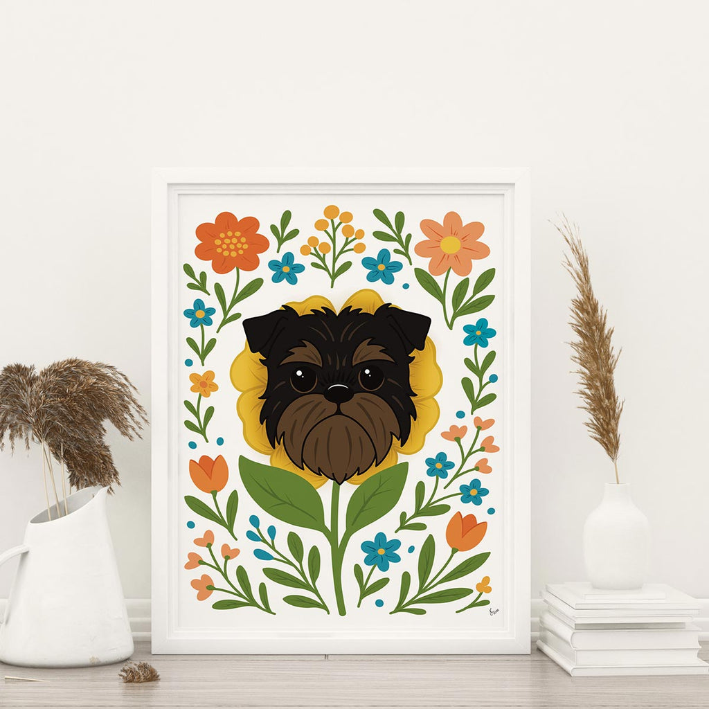 framed Brussels Griffon flower art print featuring a black and tan Griffon dog's face framed by a yellow flower surrounded by orange and teal flowers and green leaves and stems on a white background, frame not included with purchase