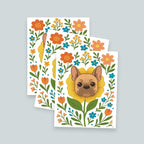 stack of 3 French Bulldog flower art prints featuring a brown and tan frenchie face framed by a yellow flower surrounded by orange and teal floral blooms and green leaf stems, print is on a white background