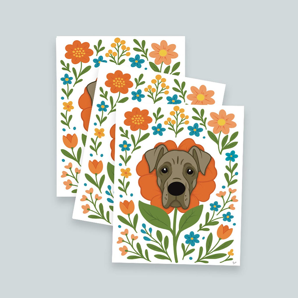 stack of 3 Great Dane flower art prints featuring a gray Great Dane's face framed by an orange flower surrounded by orange and teal flowers and green stems and leaves, on a white background