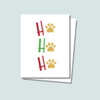Ho Ho Ho Christmas Holiday card featuring red and green letters with gold paw prints in place of the "O" of all 3 Ho Ho Ho's, on a white background