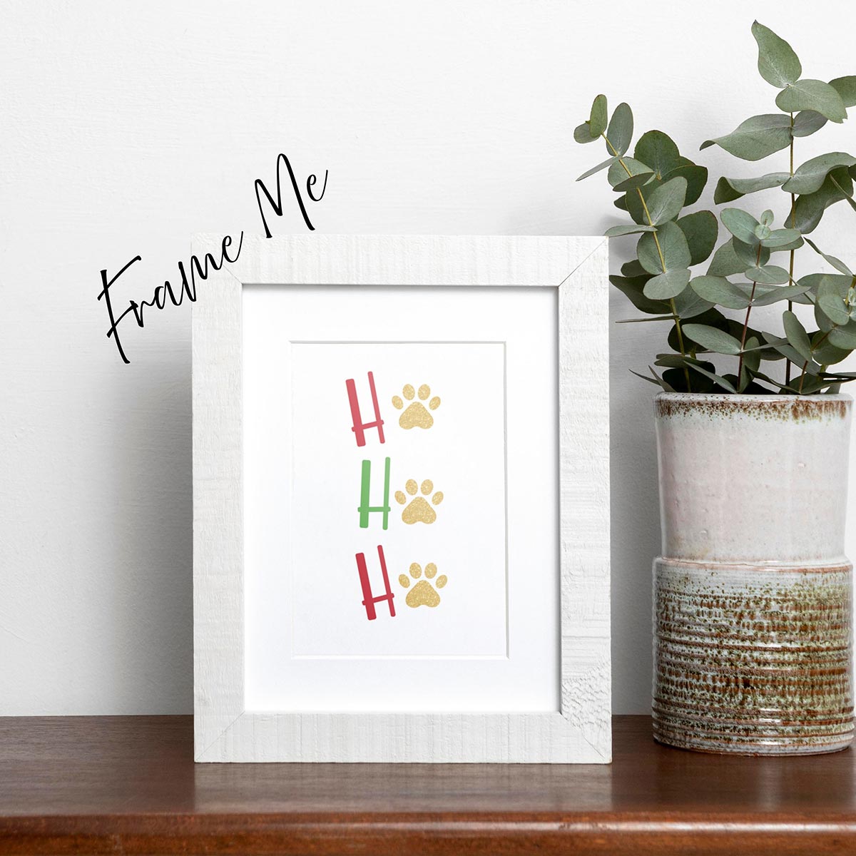 framed Ho Ho Ho Christmas Holiday card featuring red and green letters with gold paw prints in place of the "O" of all 3 Ho Ho Ho's, on a white background, frame not included in purchase
