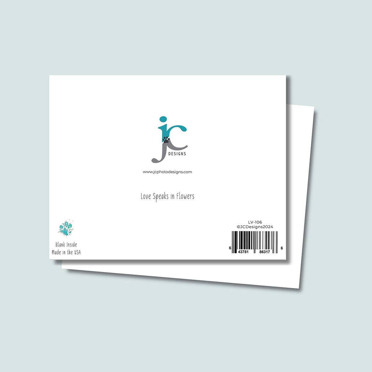 back of Love Speaks in Flowers card showing JC Pet Designs logo and a unique tagline message that reads "Love Speaks in Flowers", in bottom left corner is Oz's paw print in teal above the text "blank inside, made in the USA", the sku and barcode are in the bottom right corner