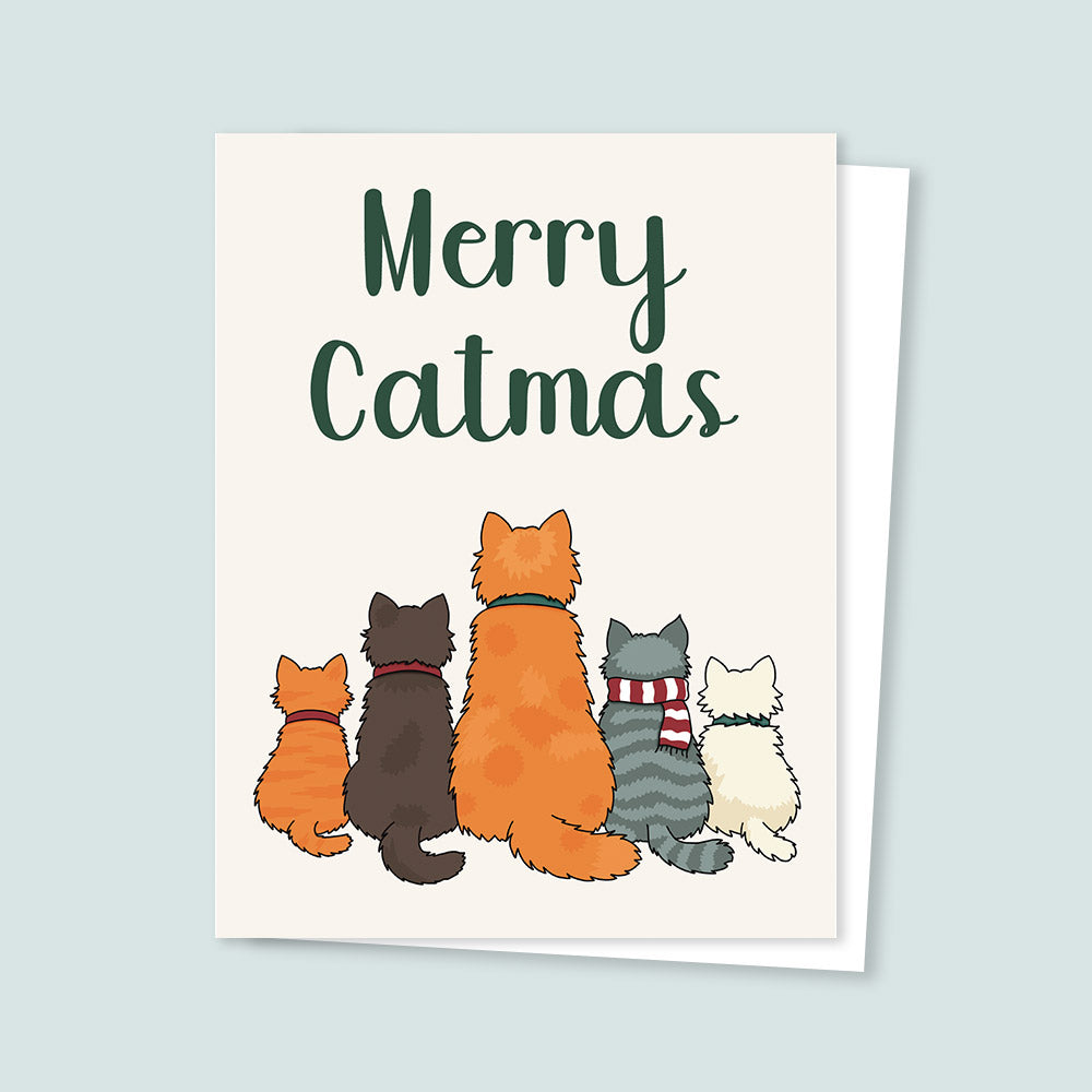 Christmas greeting card reading “Merry Catmas” with an illustration of five cats sitting side by side.