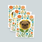 set of three art prints stacked with pug flower art print on top, art print features a brown pug's face framed by a yellow flower and surrounded by colorful orange yellow and teal blooms with green leaves and stems on a white background