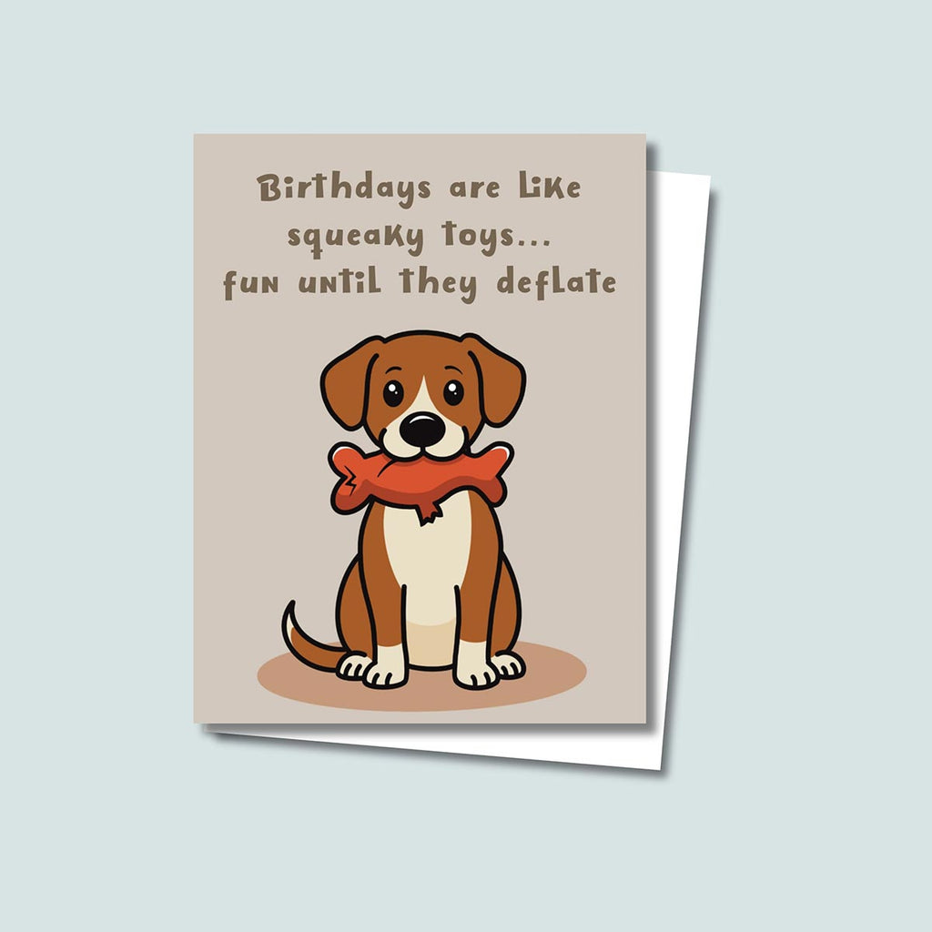 funny Squeaky Toys birthday card featuring a cute brown and white dog sitting downwith a deflated red squeaky toy with chew tear in its mouth, text on top of card reads "Birthdays are like squeaky toys...fun until they deflate", the card has a light muted brown background