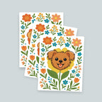 set of three Terrier Flower art print featuring a brown terrier face framed by an yellow flower surrounded by orange and teal flowers and green stems leaves on a white background